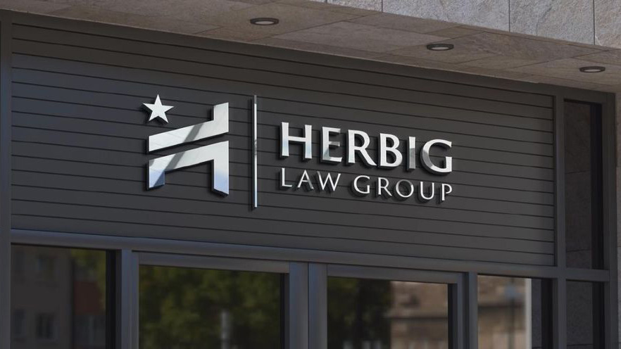 Herbig Law Group sign on the firm’s office building